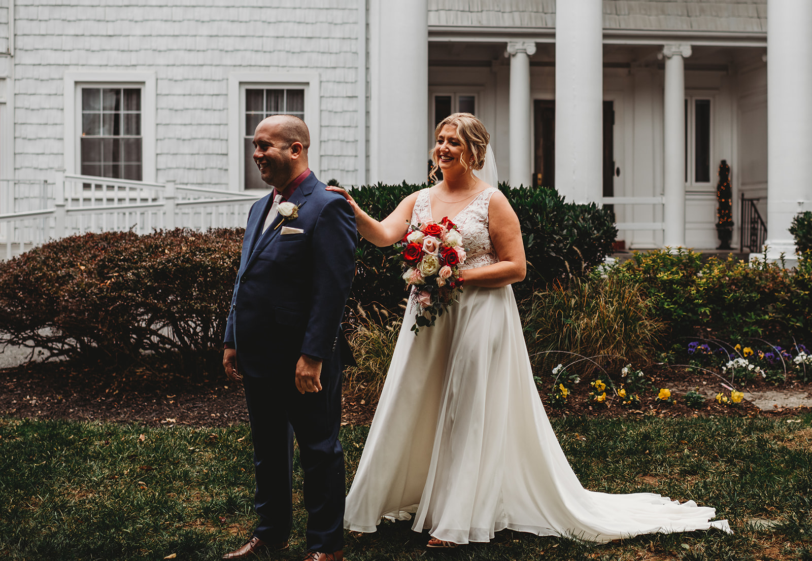 Bride tops on her groom shoulders as he faces the other way for a surprise first look before the wedding ceremony photographed by Maryland wedding photographer