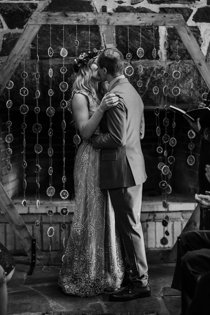 bride and groom kissing at the end of their wedding ceremony captured by Maryland wedding photographer