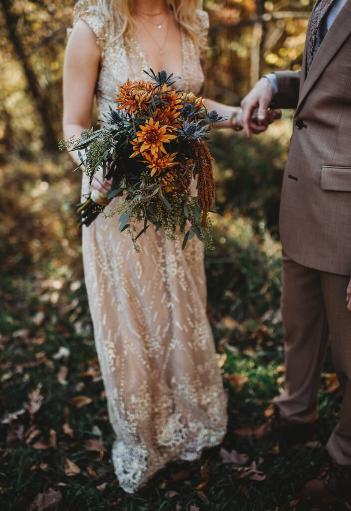 Maryland wedding photographer captures detail shot of brides wedding bouquet as she holds it down by the side of her dress for her Patapsco Valley State Park wedding
