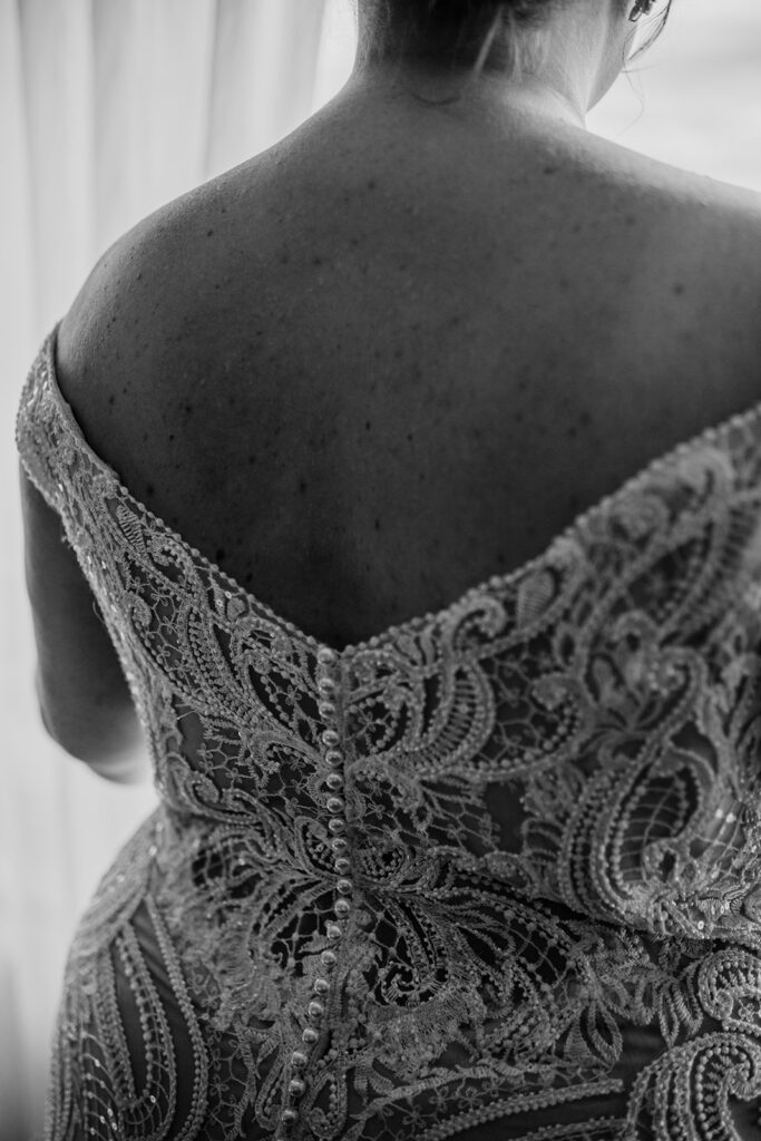 detail shot of back of wedding dress with buttons and lace photographed by Maryland wedding photographer for a Baltimore wedding