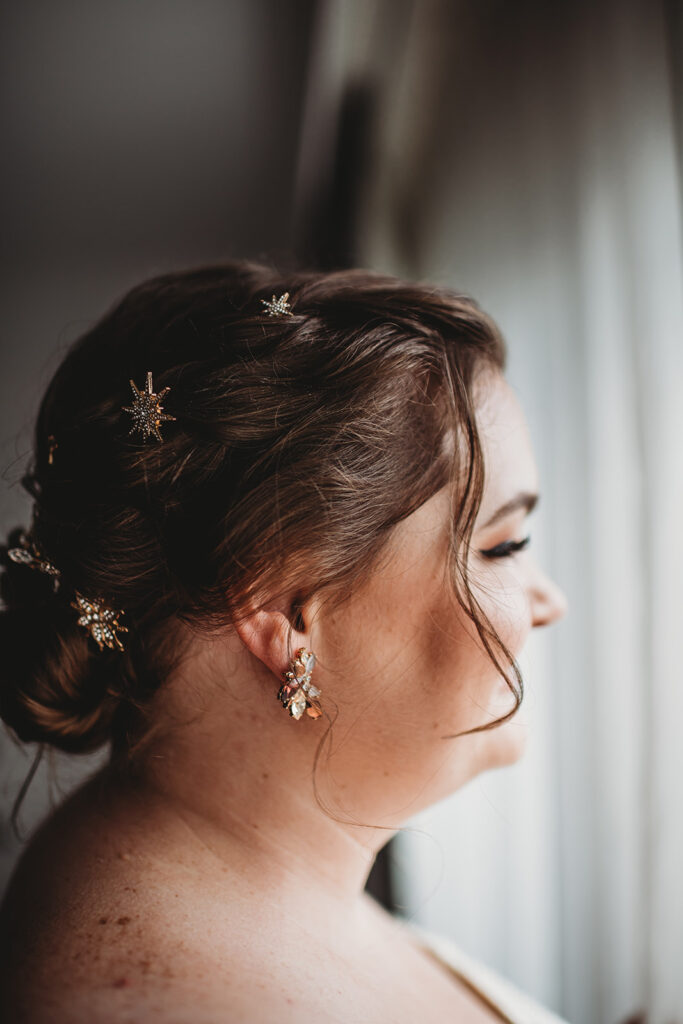 detail shot of bridal hair with small star pins in a low bun in her hair captured by Baltimore wedding photographers