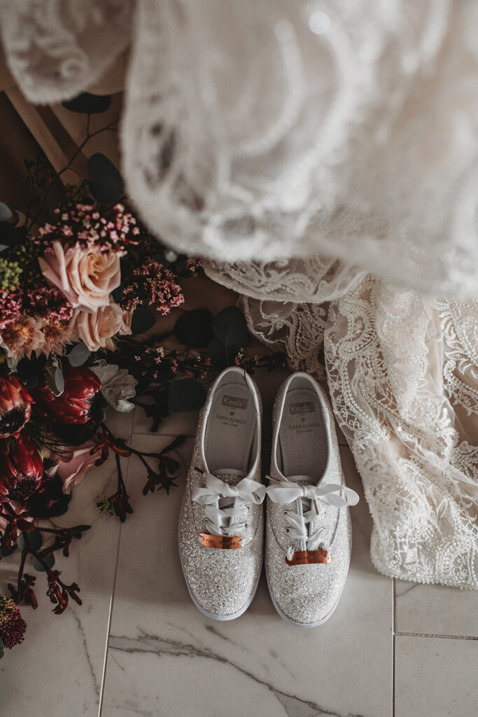 Maryland wedding photographer captures detail shot of brides gown, shoes and florals