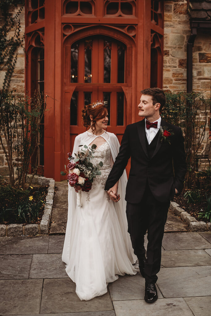 Baltimore wedding photographers capture couple walking out of venue hand in hand