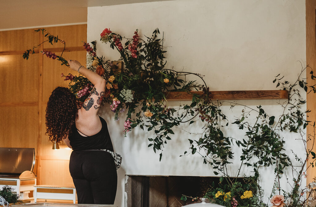 Baltimore wedding photographers capture florist installing floral piece at event