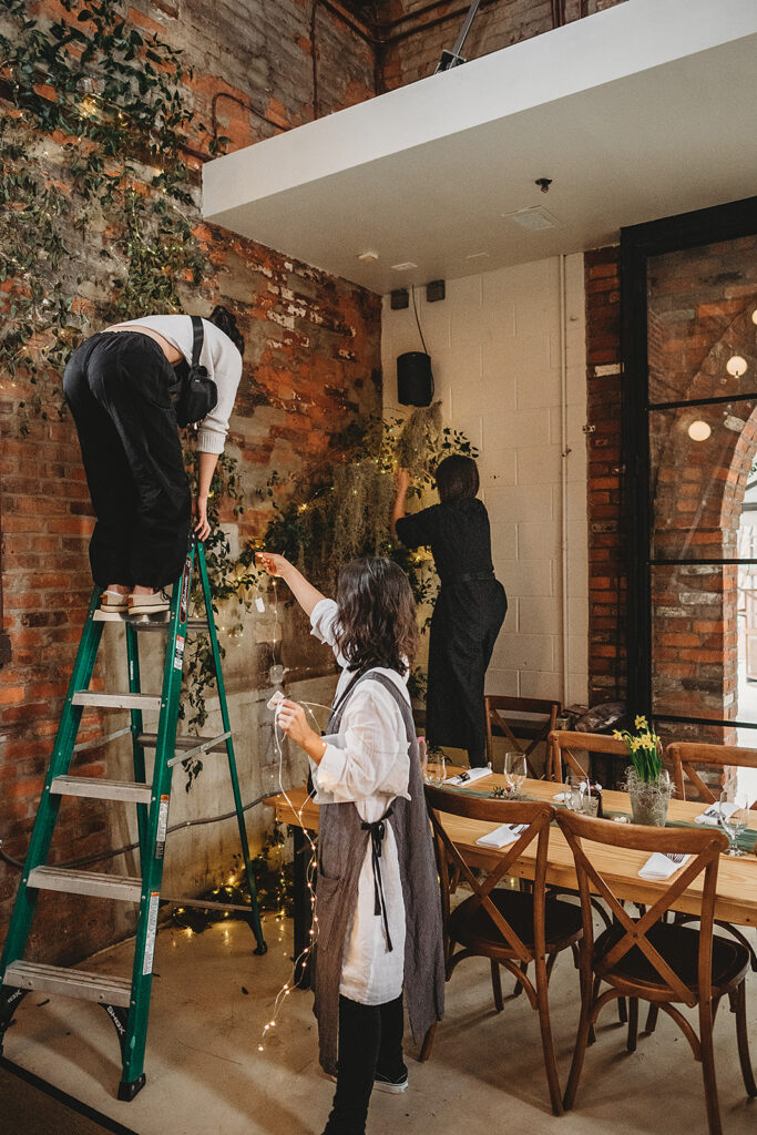 Baltimore wedding photographers capture woman on ladder with flowers