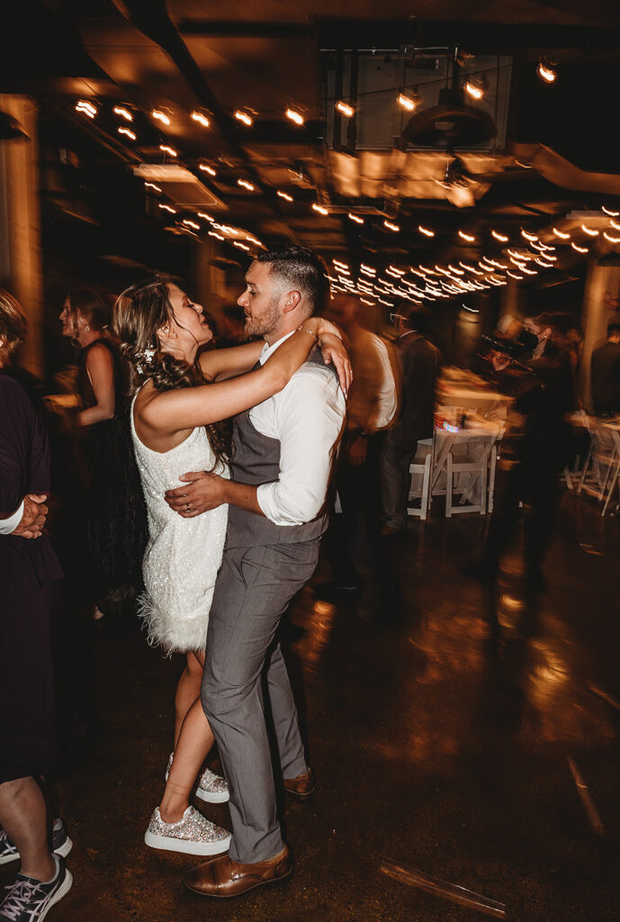 bride and groom dancing during their reception captured by Baltimore photographers with studio lights