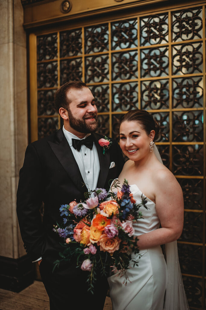 Baltimore wedding photographers capture bride and groom hugging outside Riggs Hotel