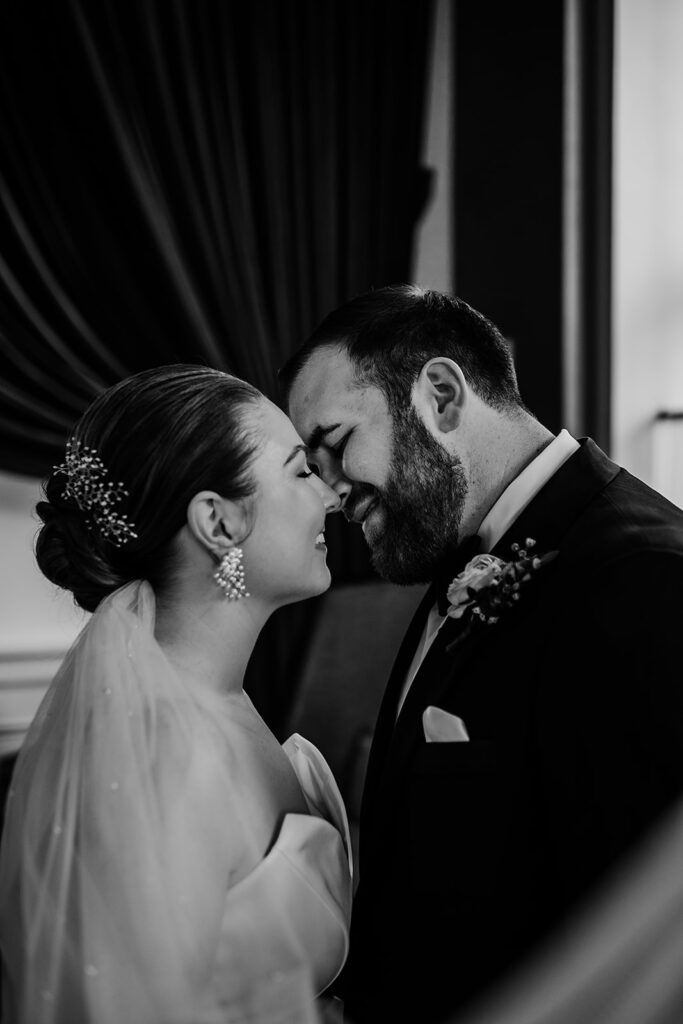 Baltimore wedding photographers capture bride and groom kissing in black and white portrait