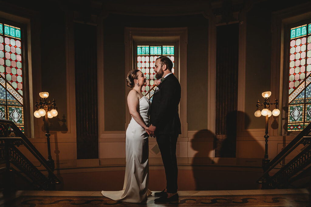 Baltimore wedding photographer captures couple holding hands in Riggs Hotel after DC wedding