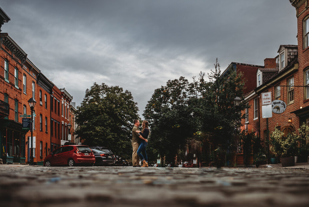 Baltimore wedding photographers capture couple hugging in the street