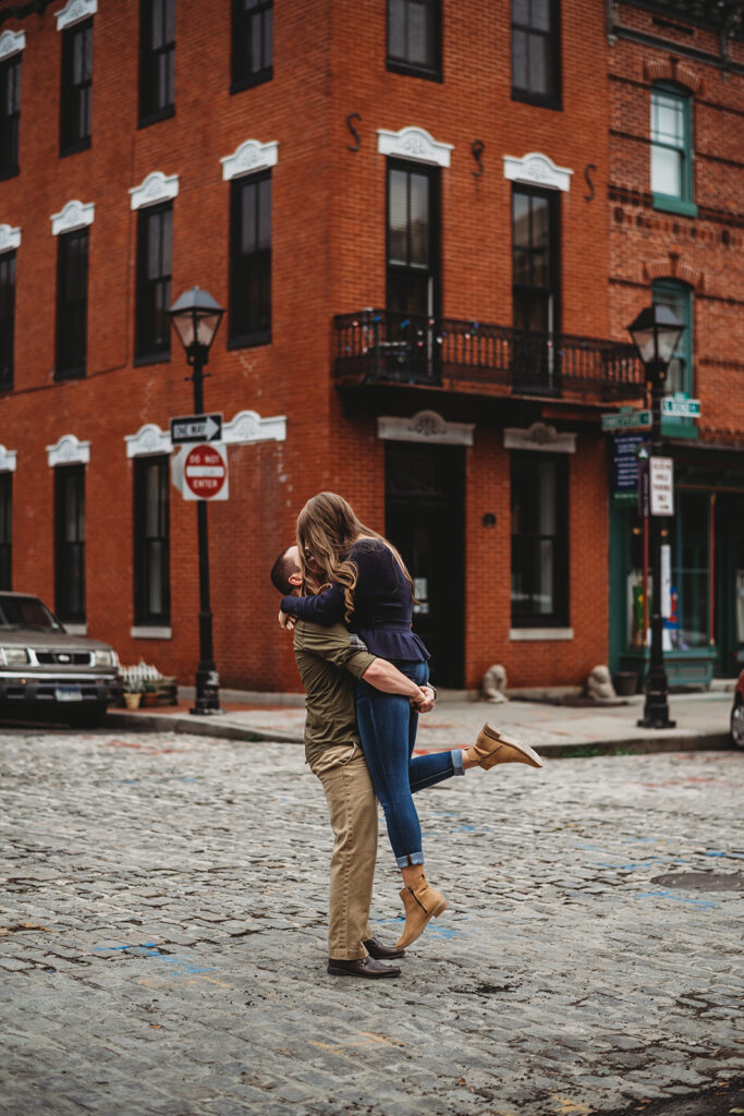 Baltimore wedding photographers capture man lifting woman in downtown