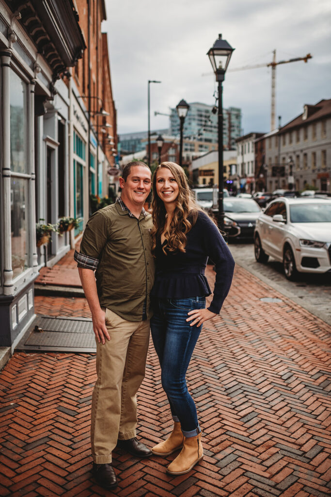 Baltimore wedding photographers captures couple standing side by side during Fells Point engagement photos