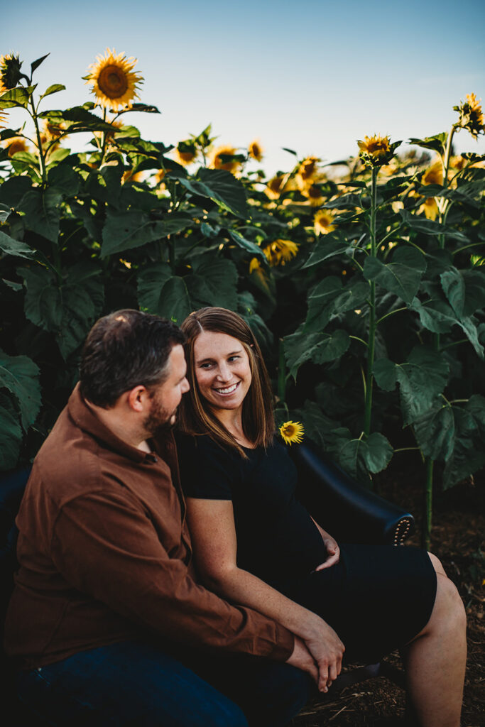 Baltimore photographers capture man and woman sitting in sunflower field together