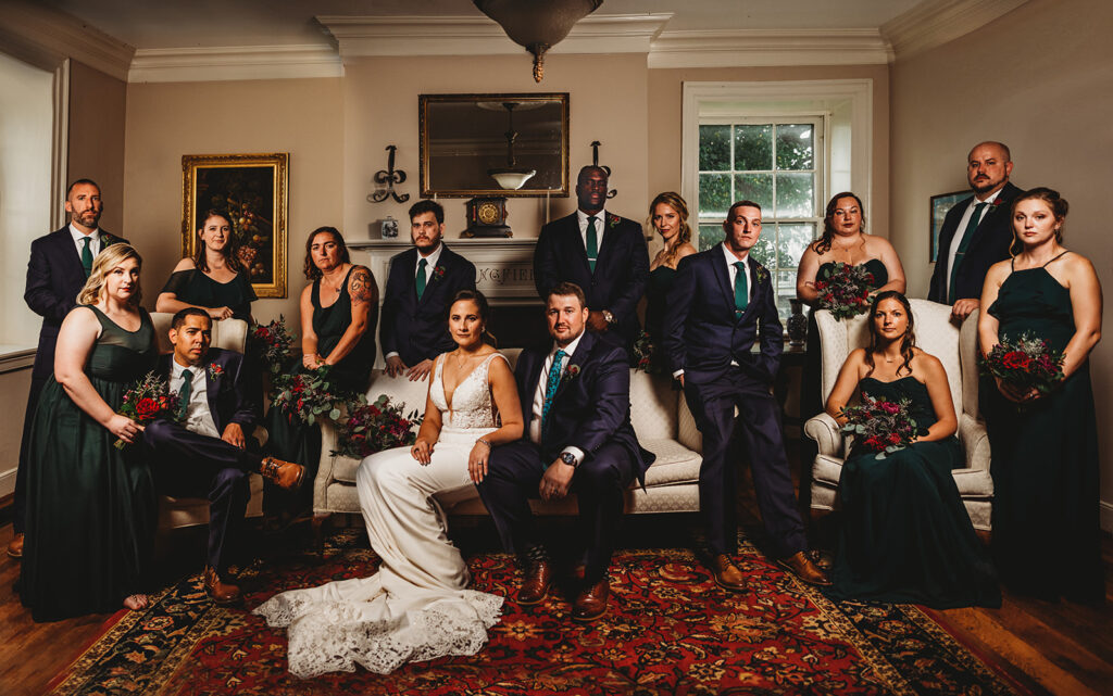 Baltimore wedding photographers capture bride and groom sitting on couch with wedding party