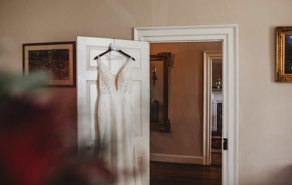 Baltimore wedding photographers capture wedding dress hanging on door 