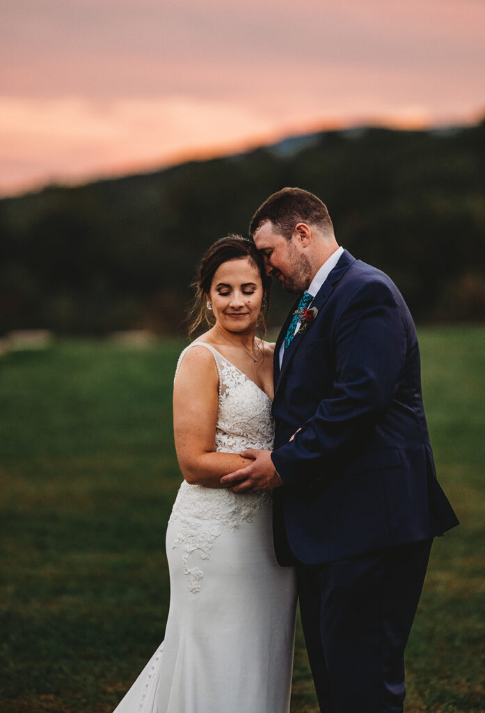 Baltimore wedding photographers capture couple hugging during sunset bridal portraits