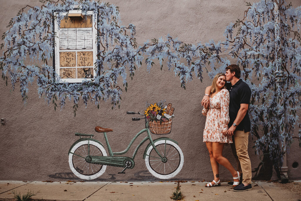 Baltimore wedding photographers capture couple standing together with bike
