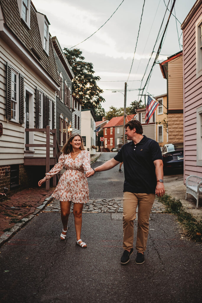 Baltimore wedding photographers capture couple running through the streets holding hands