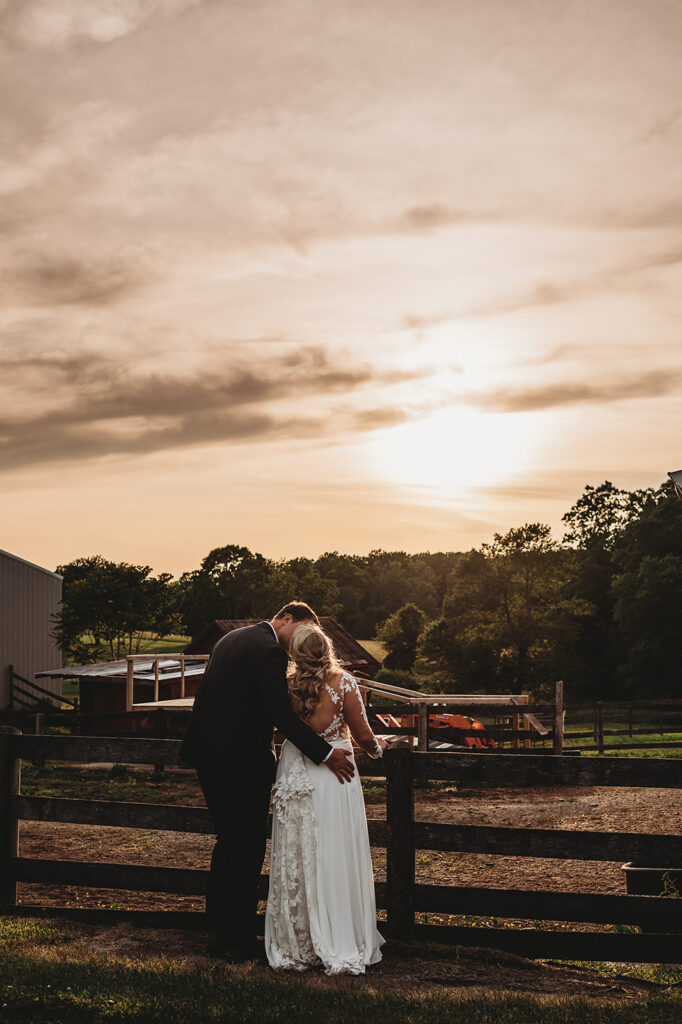 Maryland wedding photographer captures couple hugging at sunset watching together