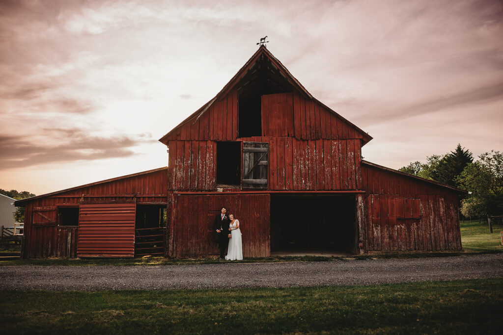 Maryland wedding photographer captures couple standing in front of barn