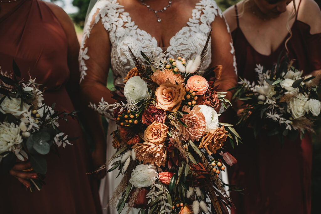 Maryland wedding photographer captures bride holding bouquet with bridesmaids