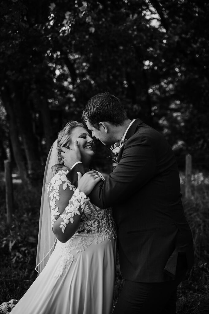 Baltimore wedding photographers capture black and white portrait of them kissing