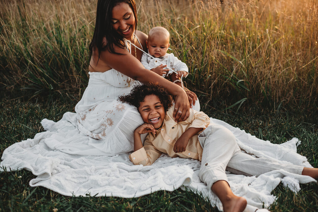 Baltimore photographer captures mother sitting on blanket with children during family portraits