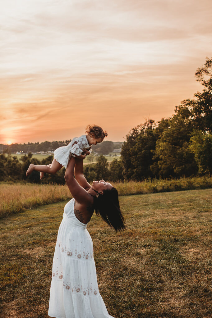 Baltimore photographer captures mother lifting baby in air 