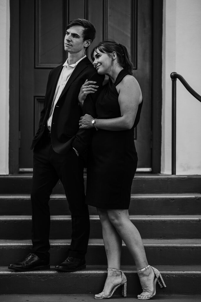 Maryland engagement photographers capture black and white portrait of couple standing together on stairs 