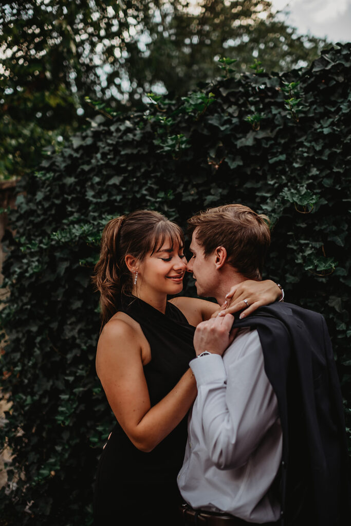 Maryland engagement photographers capture woman wrapping arms around man's neck and touching noses