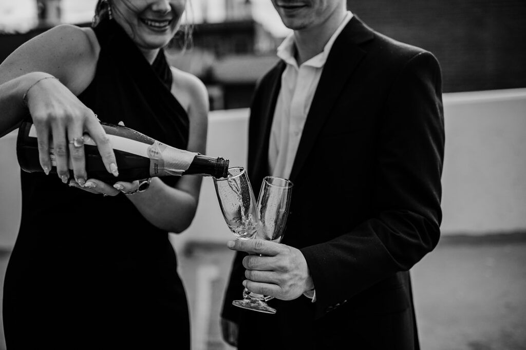 Maryland engagement photographers capture woman pouring champagne into glasses