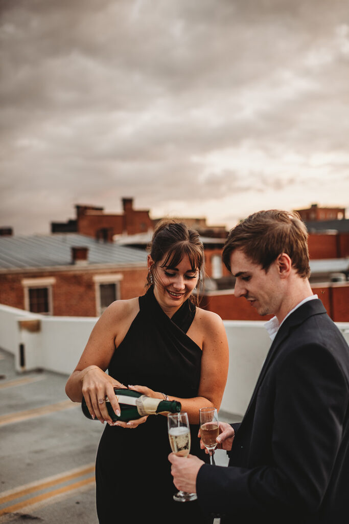 Maryland engagement photographers capture woman pouring champagne in glasses