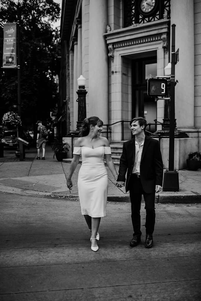 Maryland engagement photographers captures black and white portrait of newly engaged couple walking hand in hand