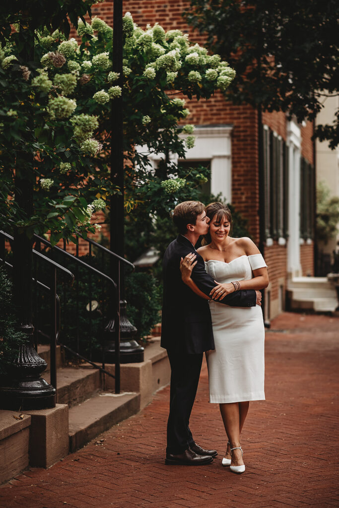 Baltimore wedding photographer captures couple hugging during outdoor engagement portraits