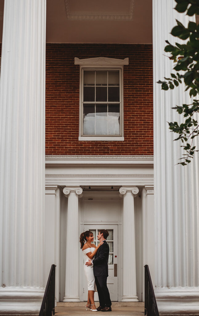 Maryland engagement photographers capture couple standing on porch together 