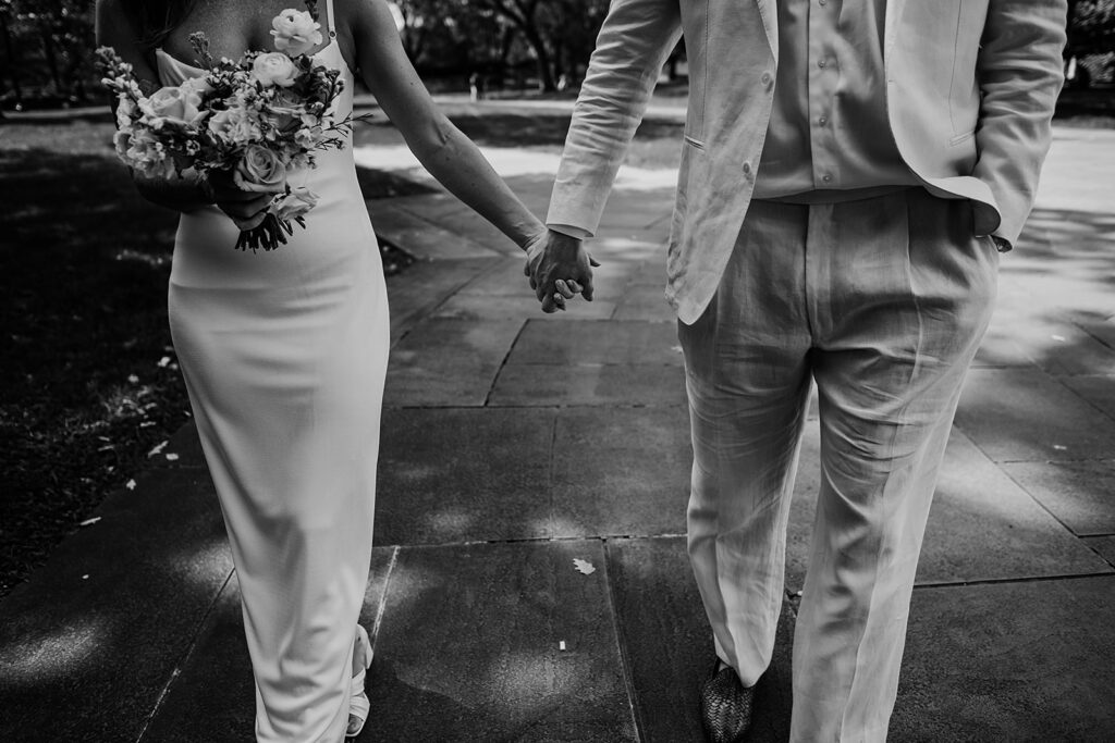Baltimore wedding photographer captures couple walking and holding hands after war memorial wedding
