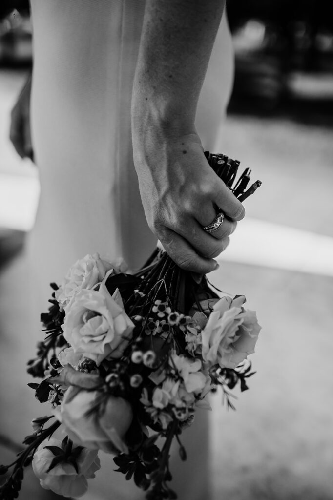 Baltimore wedding photographer captures bride holding bridal bouquet in black and white portrait