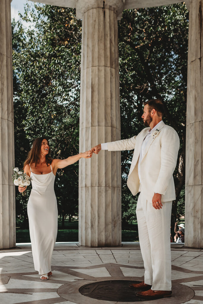 Baltimore wedding photographer captures bride and groom holding hands during portraits
