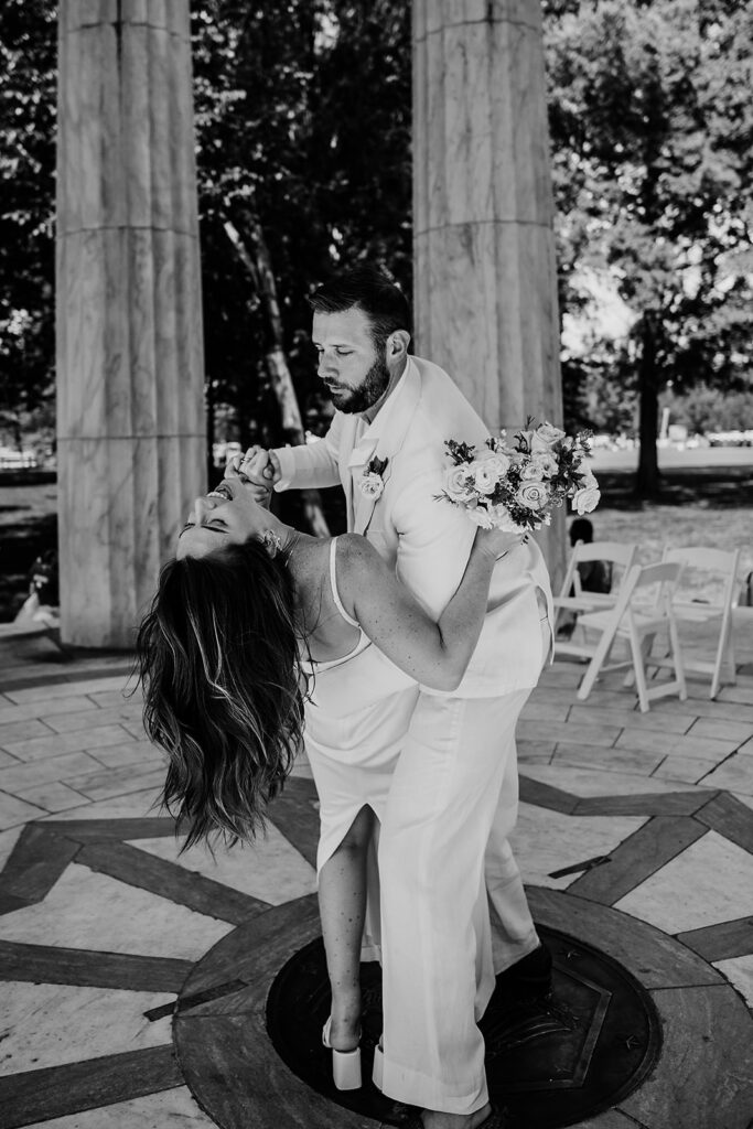 Baltimore wedding photographer captures groom dipping bride during bridal portraits