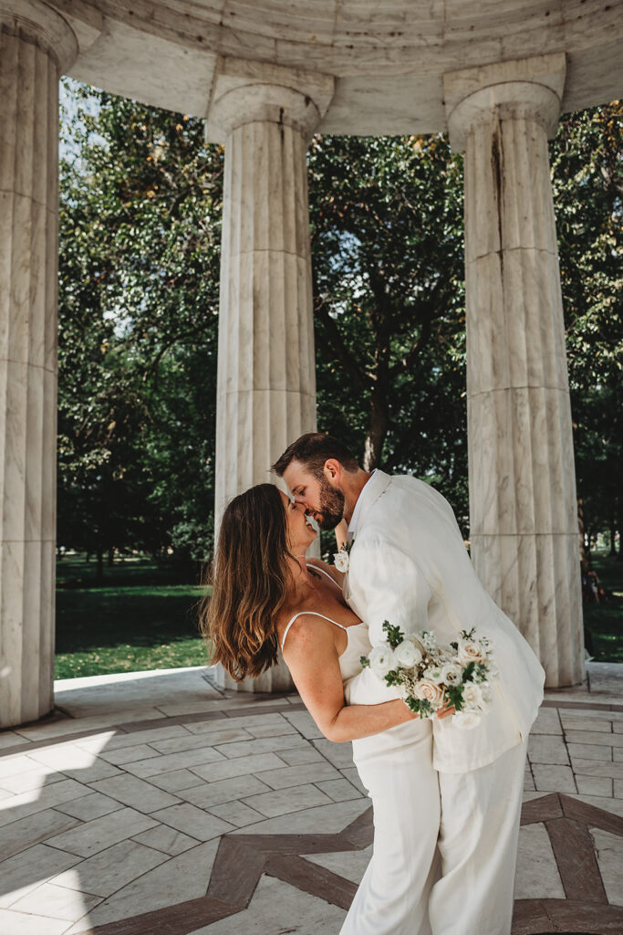 Maryland wedding photographer captures groom kissing bride after War Memorial wedding