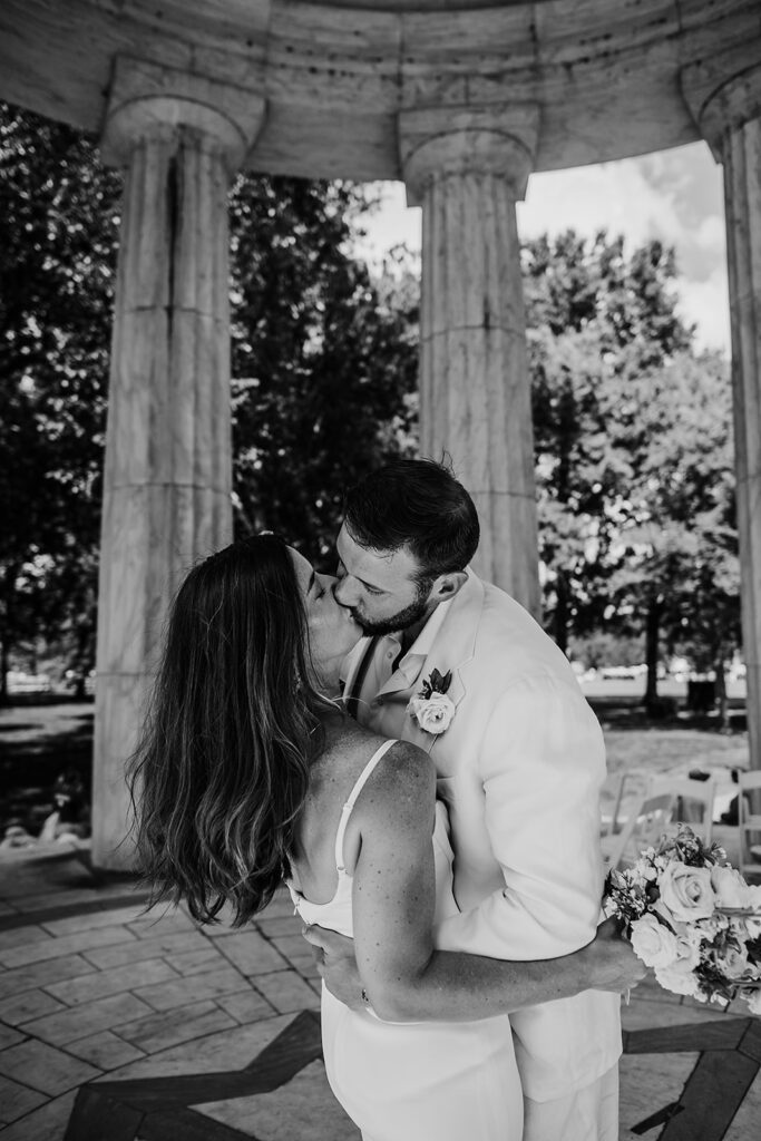 Baltimore wedding photographer captures black and white portrait of bride and groom kissing