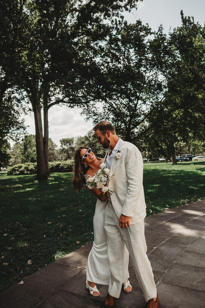 Baltimore wedding photographer captures bride laughing at groom while wearing sunglasses