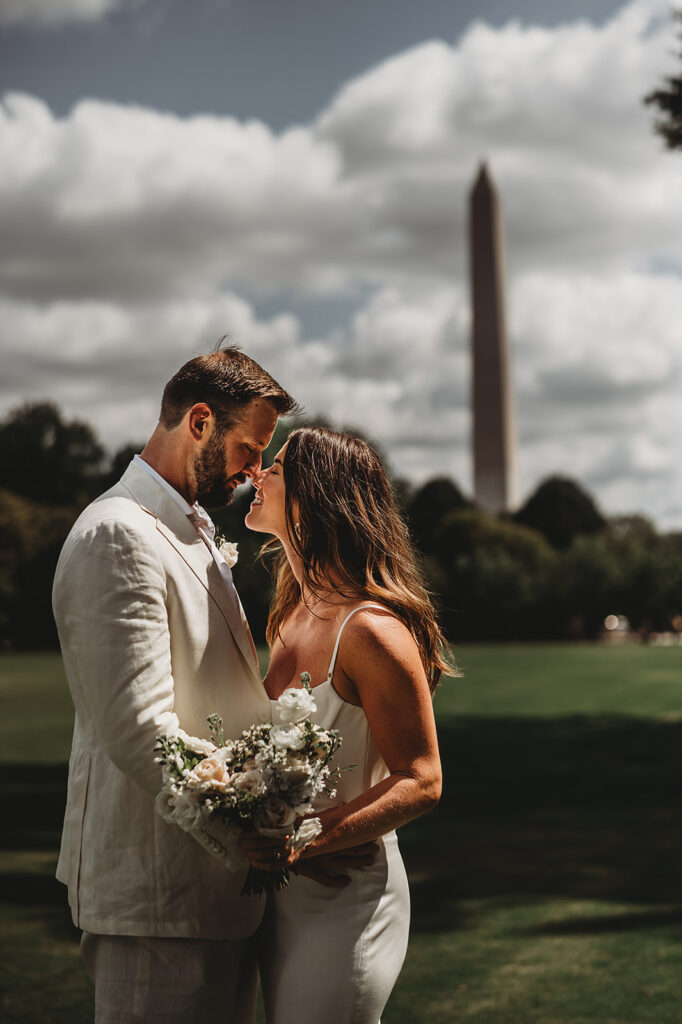 Baltimore wedding photographer captures couple kissing in front of memorials after wedding