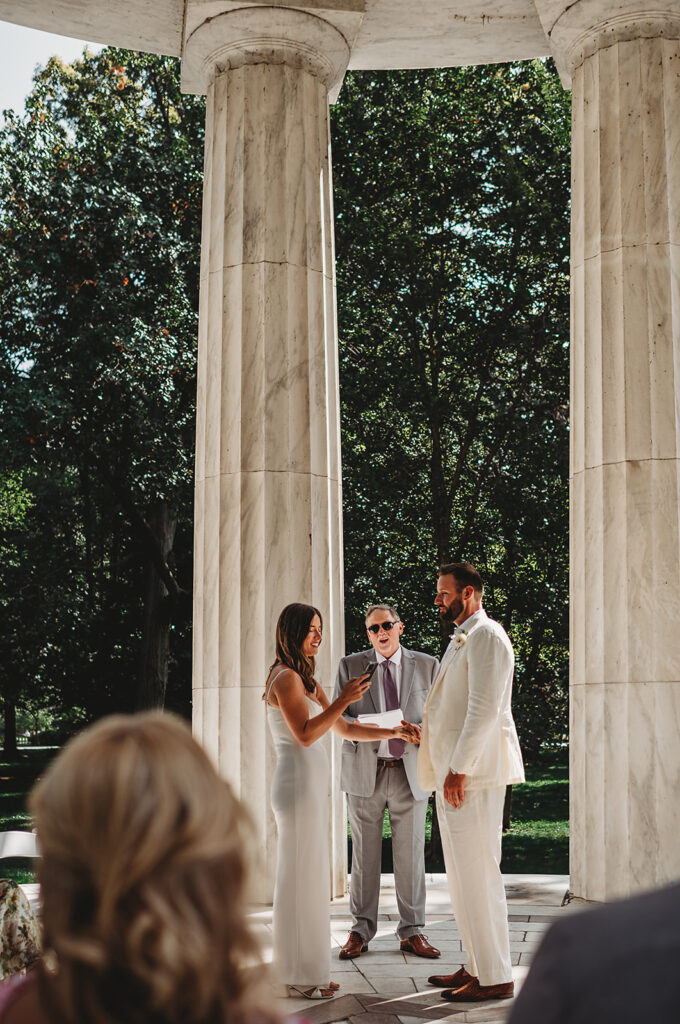 Baltimore wedding photographer captures bride reading vows during war memorial ceremony
