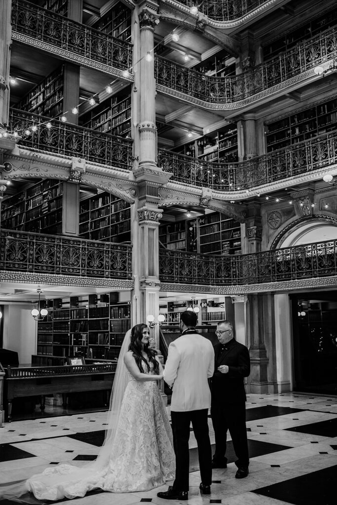 Baltimore wedding photographer captures bride and groom holding hands at Baltimore Library wedding 