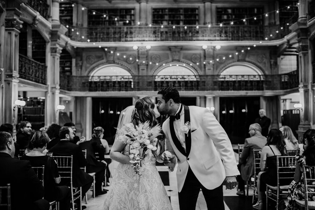 Baltimore wedding photographer captures bride and groom kissing during wedding ceremony