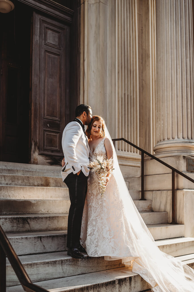 Baltimore wedding photographers capture groom kissing bride's forehead