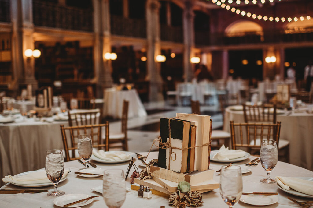 Baltimore wedding photographer captures table settings with centerpieces with stacks of books