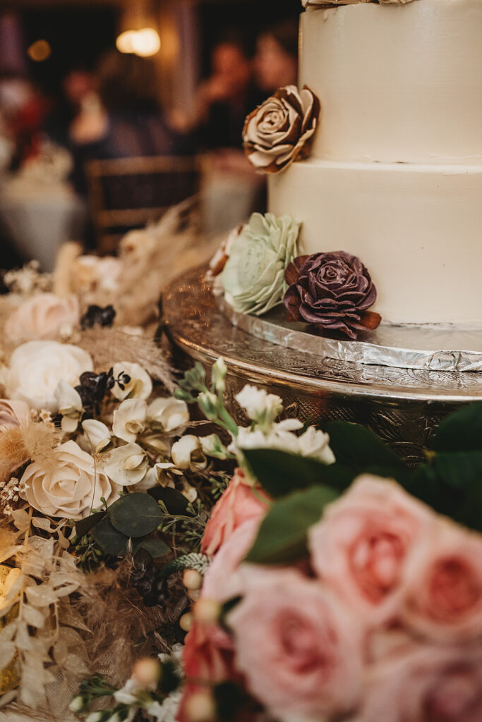 Baltimore wedding photographer captures close up of wedding cake with succulents and flowers surrounding