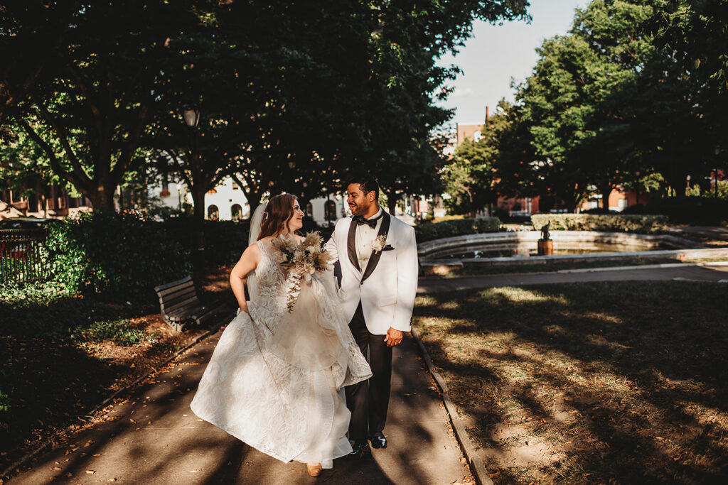 Baltimore wedding photographer captures newly married couple walking hand in hand 